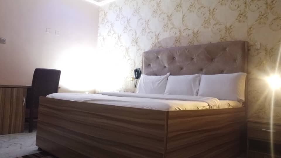 Double King Room with armchair and reading lamp