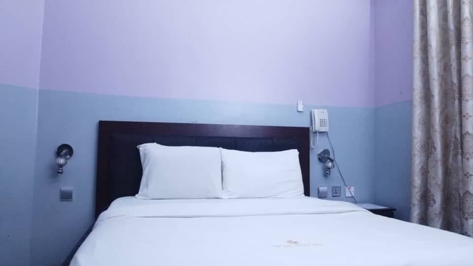 Deluxe Room with a king bed and an upholstered armchair
